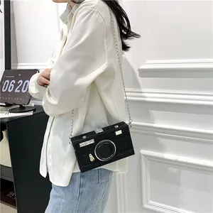 Fashionable black camera-shaped crossbody box bag with glitter finish and chain strap
