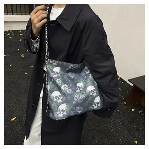 Detailed view of large trendy skull and floral print crossbody bag with LOVE text strap