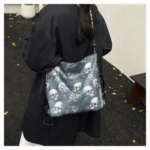 Large tote bag with skull and floral print carried by a model in an outdoor setting.
