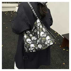 Large skull and floral print tote bag with LOVE strap shown on shoulder.