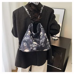 Detailed view of large capacity skull and flower print tote bag worn as a backpack