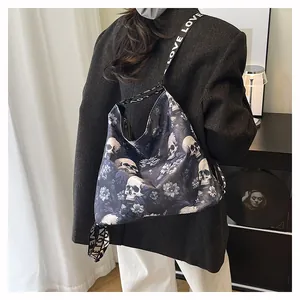 Detail view of a stylish skull and floral print large capacity tote bag on a model