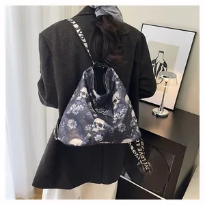 Close-up detail of a large trendy skull and floral print tote backpack worn by woman