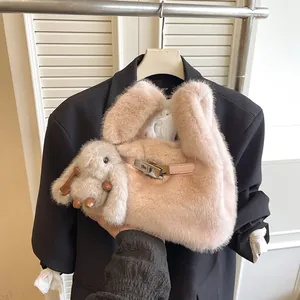 Close-up of pink plush handbag with cute rabbit charm and metal lock detail