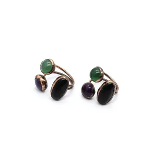 Detailed view of vintage adjustable rings with green, purple and black stones