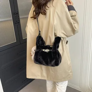 Elegant black fluffy rabbit ear handbag with silver clasp detail worn over a beige coat