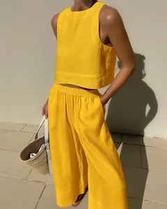 Close-up view of bright yellow linen two-piece set with sleeveless top and wide leg pants