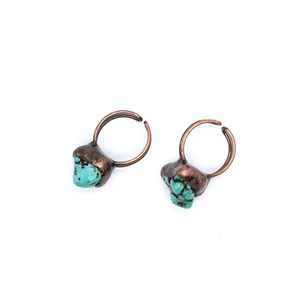 Detailed view of vintage copper adjustable open rings with turquoise raw stones on white