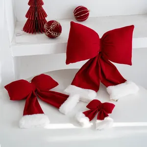 Festive red plush bows with white fur trim, Santa hat style Christmas tree ornaments.