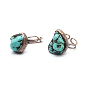 Detailed close-up of antique copper adjustable ring featuring irregular turquoise stone.