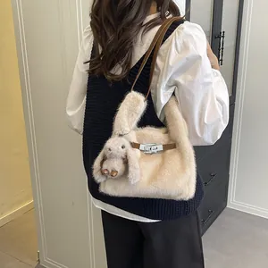 Trendy plush shoulder bag with cute rabbit pendant for autumn and winter fashion
