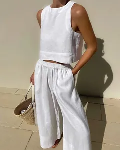 Detailed view of women's white linen two-piece set with sleeveless top and wide-leg pants
