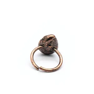 Detailed macro view of antique bronze adjustable ring with irregular stone texture detail