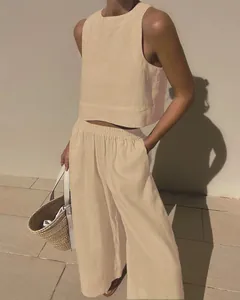 A close-up of a minimalist beige linen sleeveless top and wide-leg pants set