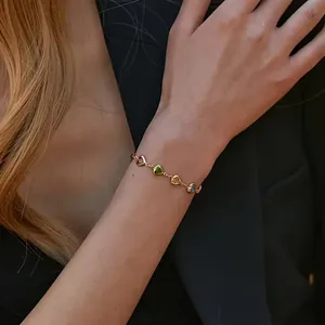 Gros plan d'un bracelet de luxe plaqué or 18 carats avec des zircons en cœur.