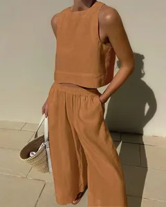 Outdoor detail of a two-piece linen set with a sleeveless top and wide pants.