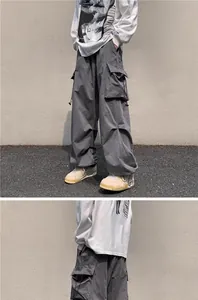Close-up detail of grey vintage techwear cargo pants with functional drawstring pockets