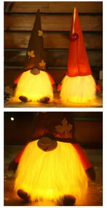 Close-up of glowing Thanksgiving gnomes with warm LED light and maple leaf hats