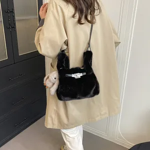 Stylish black faux fur crossbody bag with a cute bunny charm on a beige trench coat