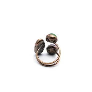Close-up detail of the antique copper adjustable ring featuring multi-color stones