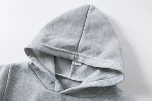 Detail view of a grey children's hoodie showing fabric texture and size tag