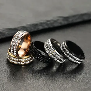 Close-up of double-row rhinestone stainless steel rings in gold, black, silver, rose gold.