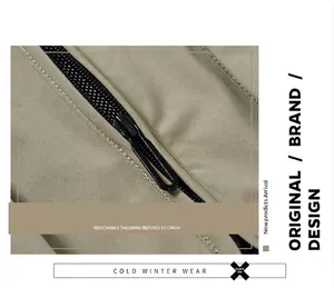 Close-up detail of a durable black zipper on khaki outdoor waterproof fishing vest fabric