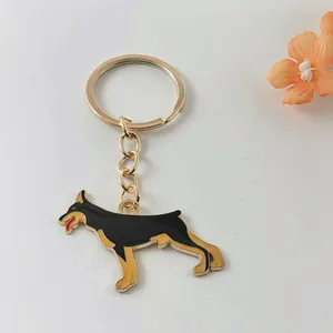 Detailed macro view of a Doberman Pinscher metal keychain with black enamel finish