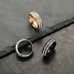 Macro detail showing exquisite double row crystal inlay on titanium steel rings in three colors.