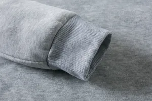 Close-up of gray kids sweatshirt ribbed cuff detail showing soft cotton fabric texture