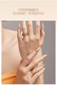 Detail view of model wearing gold leaf and flower rings with elegant styling.