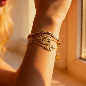 Elegant gold triple-layered bracelet featuring monstera leaf charms and a snake chain