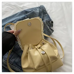 Detailed view of cream faux leather backpack with lace trim and magnetic snap