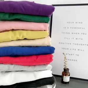 Vibrant stack of soft children's solid color hoodies in assorted autumn tones