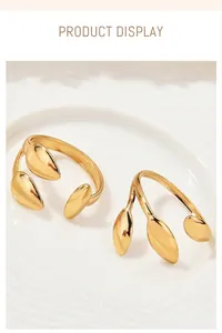 Detailed close-up of two vintage gold-colored plant series rings with leaf designs