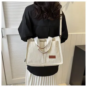 Large capacity cream corduroy fashion tote bag shown from back view worn on shoulder