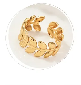 Close-up of the delicate golden leaf design and matte texture of this adjustable ring