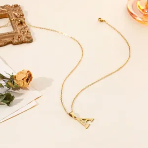Detail of a vintage 18k gold plated stainless steel necklace with initial A pendant