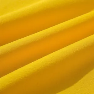 Macro view of soft yellow knit cotton fabric texture for children's autumn winter sweatshirt