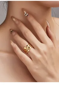 Detailed view of a vintage gold floral ring worn on a finger with an elegant pose