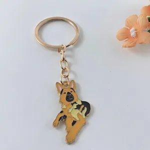 Close-up of a German Shepherd enamel keychain with a gold-colored metal ring.