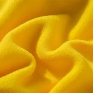Macro detail of soft yellow fleece fabric showing warm and cozy texture for children sweatshirt