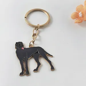 Detailed close-up view of a black dog enamel keychain with a gold-tone metal ring for keys