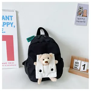 Cute black children's backpack featuring a soft 3D plush teddy bear for kindergarteners