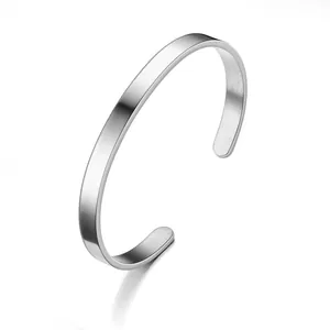 Detail of a minimalist silver stainless steel C-shape cuff bracelet with polished finish.