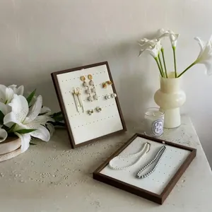 Elegant walnut wood jewelry display stand set for earrings and necklaces on white desk