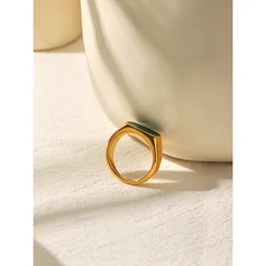 Macro detail view of a French retro gold stainless steel ring featuring green enamel inlay