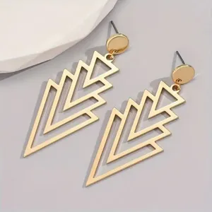 Close-up of elegant gold geometric layered triangle drop earrings with minimalist style