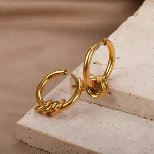 Retro gold-plated hoop earrings with triple small rings on a textured stone base
