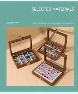 Detail of walnut grain jewelry box with glass lid and ring display compartments